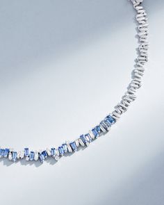 Handcrafted in 18-karat, this tennis necklace features over 11 carats of vivid light blue sapphire baguettes which are complimented by baguette and round white diamonds. This tennis necklace is a masterpiece, its design ensures both comfort and flexibility, making it an exquisite choice for any occasion. Details 18k white gold 11.16 carats of light blue sapphire baguettes 3.64 carats of baguette and round white diamonds Necklace measures 17" inches in length Box clasp with safety lock fastening Tennis Necklace With Baguette Diamonds As A Gift, Luxury Blue Baguette Diamond Jewelry, Blue Diamond Jewelry With Baguette Diamonds, Fine Jewelry Blue Baguette Diamonds, Fine Jewelry With Blue Baguette Diamonds, Blue Baguette Cut Necklaces For Gifts, Sapphire Tennis Necklace, White Diamond Necklace, Light Blue Sapphire