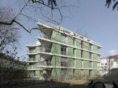 an apartment building with balconies on the second floor