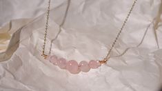 This beautiful and elegant Rose Quartz necklace - features the gentle and soothing gemstone that symbolizes the essences of unconditional love and a warm embrace. This bracelet is handcrafted with premium gold plated anti-tarnish brass wire. Designer grade A faceted rose quartz imported from Japan will dress up any outfit and its simple design allows it to be stackable with any other pairings! All pieces are made with lots of love! I hope that my creations can spark some joy into your hearts &lt Elegant Adjustable Rose Quartz Crystal Necklace, Elegant Rose Quartz Beaded Necklace, Minimalist Rose Quartz Birthstone Jewelry, Elegant Handmade Rose Gold Crystal Necklace, Minimalist Rose Quartz Crystal Necklace For Gift, Minimalist Rose Quartz Crystal Necklace Gift, Elegant Rose Quartz Crystal Necklace In Rose Gold, Elegant Rose Quartz Necklace Gift, Elegant Rose Gold Crystal Necklace For Healing