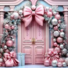 a pink door decorated with ornaments and bows