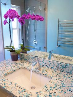 a bathroom sink sitting under a mirror next to a window