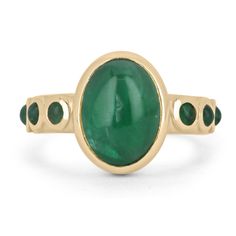 Featured is a stunning natural emerald cabochon unisex ring. This one-of-a-kind piece features a large 4.54-carat oval cut emerald cabochon as the center stone. It displays many good qualities and a lush medium-dark green color. Accenting the center stone are petite, round cut emerald cabochons on both sides of the shank. All gemstones are bezel set in a gleaming 14K yellow gold setting.  Setting Style: Bezel Setting Material: 14K Yellow Gold Gold Weight: 6.2 Grams Main Stone: Emerald Cut: Cabochon Shape: Oval Cut Weight: 4.54-Carats Clarity: Translucent Color: Green Luster: Very Good Treatments: Natural, Oiling Origin: Zambia Secondary Stone: Emerald Cut: Cabochon Shape: Round Cut Weight: 0.48-Carats (Total) Clarity: Translucent Color: Green Luster: Very Good Treatments: Natural, Oiling O Fine Jewelry Green Emerald Cabochon Ring, Fine Jewelry Green Cabochon Emerald Ring, Green Cabochon Emerald Ring Fine Jewelry, Classic Cabochon Emerald Ring, Heirloom Oval Cabochon Emerald Ring, Fine Jewelry Emerald Oval Cabochon Ring, Fine Jewelry Emerald Ring With Oval Cabochon, Green Gemstone Cabochons Fine Jewelry, Yellow Gold Emerald Ring Oval Cabochon