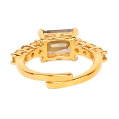 Channel your inner Princess! The center of this masterpiece is a beautiful emerald cut stone on an adjustable gold wrap band. On the band are 3 small, brilliant cut stones. The richness of colors forms a connection between power and wealth. Join the ranks of royalty with our charming Princess ring a must-have statement piece. Wonderful when stacked on your finger with your favorite gold or silver rings. Handcrafted in India. Sizable. Available in Amethyst, Clear Crystal, and Smokey Crystal. Mind Gold Jewelry With Rectangular Accent Stones, Gold Jewelry With Emerald Cut Gemstone Accents, Adjustable Emerald-cut Promise Ring, Gold Crystal Ring With Gemstone Accents, Gold Emerald Ring With Rectangular Stone, Gold Crystal Open Ring With Gemstone Accents, Gold Square Cut Emerald Ring With Gemstone, Elegant Adjustable Amethyst Open Ring, Adjustable Gold Ring With Gemstone Accents