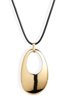 A cutout-centered teardrop pendant polished to a high shine and suspended from a waxed cord lends sculptural beauty to this statement-making necklace. 34" length 2 1/4"HX1 1/4"W (Pendant) Goldtone plate/textile with waxed coating Imported Modern Teardrop Pendant Necklaces, Modern Teardrop Large Pendant Necklaces, Modern Teardrop Pendant Necklace With Large Pendant, Gold Pendant Necklace With Adjustable Cord, Modern Tarnish-resistant Teardrop Pendant Necklace, Modern Black Oval Pendant Necklace, Black Pendant Necklace On Waxed Cord, Europe 2024, 2024 Outfits