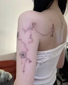 a woman with a tattoo on her shoulder