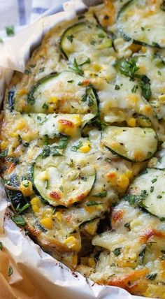 a casserole dish with zucchini, corn and cheese