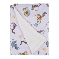 a blanket with winnie the pooh on it and other cartoon characters in purple background