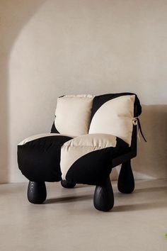 a black and white chair sitting on top of a floor