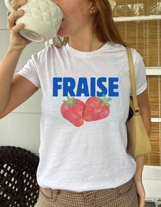 Add a pop of color to your summer wardrobe with this Strawberry Fraise Women's Baby Tee. This fitted short-sleeve crop top is made from soft cotton, offering a comfortable and breathable feel that's perfect for casual wear or layering. Its soft red color brings energy and vibrancy to any outfit, making it ideal for those who love bright colors.  The baby tee style features a close fit, giving it a trendy and y2k, early 2000s look. It's versatile enough to pair with high-waisted jeans, skirts, or Baby Tees 90s, 2000s Look, Crop Top Styles, Women Nature, Style Année 90, Garden Spring, Baby Tees, Soft Red, Blue Crop Tops