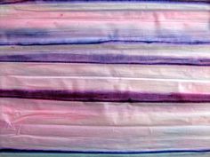 a close up view of some fabric on a piece of cloth that has been dyed pink and blue