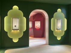 an open room with green walls and two lights on each side of the wall,