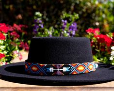 Dress up any hat with this western beaded leather hat band. Beautiful native patterns with vibrant colors. Bring a southern charm to your old favorites with this gorgeous hat band or make your new hat even more special. Made of full grain leather (highest grade leather) and glass beads. Handmade in Brazil by artisan women. You can match your hat band with our best-selling leather beaded dog collars! Treated with beeswax, water resistant. 30 days free returns or exchange. 1-year warranty. One siz Bohemian Black Hat Band For Western-themed Events, Handmade Southwestern Multicolor Hat Band, Bohemian Black Hat Bands For Ranch, Handmade Multicolor Hat Bands For Rodeo, Western Multicolor Hat Bands For Country Events, Western Style Multicolor Hat Bands For Country Events, Western-style Multicolor Hat Bands For Country Events, Black Bohemian Hat Bands For Festivals, Black Bohemian Hat Band For Festivals