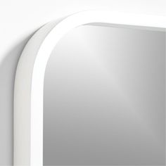 a white arched mirror mounted to the side of a wall