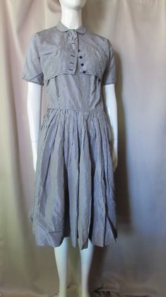 "Sweet 1960 Era summer sundress and matching bolero. In tiny black and white check taffeta. The dress has 8\" spaghetti straps and scoop neckline, 7 1/2\" deep at the back. The bodice is fitted leading to the full skirt. The back closes with 15\" metal zipper. There is an attached red taffeta crinoline (see condition report below). The bolero has Peter Pan collar with bow and short to the elbow sleeves. It closes with snap at throat and 7 buttons down the front. Size: Label says size 9--dress-34 Classic Fitted Plaid Summer Dress, Fitted Plaid Summer Dress For Daywear, Bolero Black, Summer Sun Dress, Summer Sundresses, Taffeta Fabric, Summer Sundress, Size Label, Sun Dress