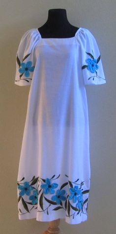 "This is a great vintage muumuu dress in a bright clean white with simple floral details on the sleeves and the hem made from individual applique flowers and embroidered leaves. The mannequin measures Bust = 33\" Waist = 24\" Hips = 34\" Measurements are approx. and taken with the dress laying flat Bust = underarm to underarm = 20\" Length = from shoulder to hem = 44\" I think this dress would look cute with a matching sash tied around the waist to give it a more fitted look. In great vintage co Moomoo Dress Muumuu, Muumuu Dress Pattern, Moomoo Dress, Hawaiian Muumuu, Island Style Clothing, Vintage Hawaiian Dress, Applique Flowers, Muumuu Dress, Dragon Heart