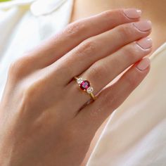 Ruby Engagement Ring, Yellow Gold Ring, Oval Cut Diamond Trilogy Ring, Wedding Ring, Promise Ring, Gemstone Jewelry, Rings, Art Deco Ring ♠ Stone Details ➵ 1.15 Ct Approx. Total Oval Cut Ruby ➵ Side Stone Weight: 0.30Ct Round Cut Simulated Diamond ➵ Band Width: 2.0mm ➵ Gemstone: Ruby ➵ Side Stone: Simulated Diamond ➵ Stone Color (Red) ➵ Stone Luster: Excellent ➵ Stone Clarity: VVS1 ➵ Stone Make: High Quality ➵ Center Stone Shape: Oval Cut Ruby ➵ Metal Change(10k/14k/18k White/Yellow/Rose Gold) ➵ Ruby Trilogy Ring, Ruby Bezel Ring, Oval Ruby Jewelry With Brilliant Cut For Weddings, Fine Jewelry Ruby Ring With Three Stones, Classic Three Stone Round Ruby Ring, Round Cut Ruby Ring With Accent Stones For Anniversary, Oval Ruby Ring With Three Diamonds, Oval Three Stone Ruby Ring With Diamonds, Oval Ruby Ring With Prong Setting For Wedding