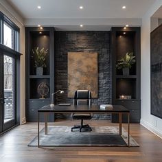 an office with black walls and wooden floors