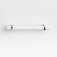 a white wall mounted toilet paper holder with two rolls on the side and one roll in the middle