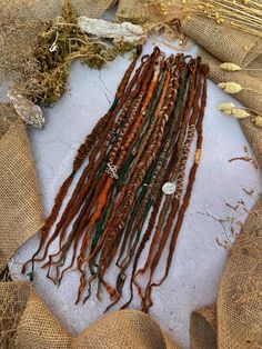 Dreadlocks extensions made of synthetic hair in ginger, forest green color decorated with metallic jewelry and natural minerals , super soft and light weight  see more colors and styles in my Etsy shop..   Description of the dreadlocks in the pictures: Textured S.E. (single ends) Dreadlocks  Length: 45cm  Thickness: ~1cm  Quantity: 20 basics, 20 ends Dreadlocks are handrcrafted wtih high-quality synthetic material, light weight. Can be used multiple times. Easy installation and removal process✨ Green Dreadlocks, Dreadlocks Extensions, Forest Green Color, Synthetic Materials, Natural Minerals, Synthetic Hair, Metal Jewelry, Forest Green, Ginger