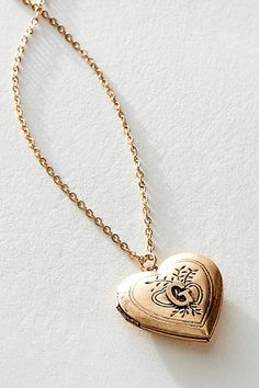 A super sweet gift or an accessory unique to you, this darling monogram necklace features a heart locket pendant with an initial engraving. **Features:** Dainty chain, heart locket pendant, hinge opening mechanism, monogram initial engraving, clasp closure **Why We | Monogram Necklace by Free People in Gold Heart-shaped Vintage Charm Jewelry For Keepsake, Vintage Personalized Open Heart Jewelry, Personalized Antique Jewelry For Valentine's Day, Vintage Charm Heart Pendant Locket Necklace, Vintage Heart Charm Necklace Engraved, Vintage Charm Necklace For Anniversary, Heart Charm Medallion Jewelry For Anniversary Gift, Vintage Personalized Heart Necklace For Anniversary, Vintage Engraved Heart Necklace For Anniversary