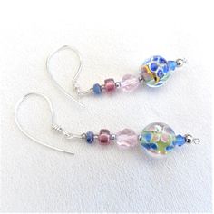 These beautiful Boho 'Flower Earrings', are constructed using non tarnish silver wire, and the ear wires are hammered, for a luxurious effect. Included are stunning Millefiori glass beads, showing fascinating floral inclusions, in blue, pink, yellow, green, and, light brown. Dark pink Czech glass drum beads, large round, pink, Czech glass facetted beads, and small blue fire polished Czech glass Rondelle beads also star in these fabulous earrings. Adjustable Czech Glass Earrings With Faceted Beads, Glass Faceted Beads Earrings For Gift, Glass Earrings With Faceted Beads For Gift, Glass Earrings With Faceted Beads As A Gift, Silver Dangling Beads Glass Earrings, Silver Glass Earrings With Dangling Beads, Silver Earrings With Dangling Glass Beads, Wire Wrapped Glass Bead Earrings, Nickel-free Czech Glass Earrings For Jewelry Making