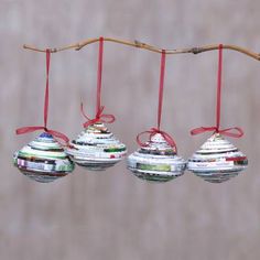 three christmas ornaments hanging from a tree branch