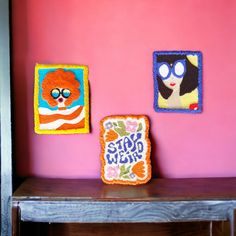 two pieces of bread sitting on top of a wooden table next to a pink wall