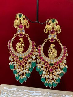 Premium quality High gold plated, pearl work, hand carved work , AD lining and kundan work. Clip back.  about 5.5 inch long  Absolute designer piece and statement earring. Luxury Kundan Danglers For Ceremonial Occasions, Luxury Ornate Chandbali Bridal Earrings, Luxury Fusion Chandbali Danglers, Luxury Green Chandbali Earrings, Luxury Kundan Chandbali Chandelier Earrings, Luxury Green Chandbali Jhumkas, Luxury Cutdana Chandbalis For Festive Occasions, Luxury Green Chandbalis In Fusion Style, Luxury Multi-stone Chandbali Earrings