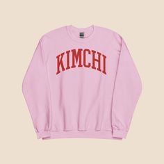 "🎄Don't Miss Out: Order by December 10 to get it by Christmas!🎄 🇰🇷 🥬  Ready to look cute and feel cozy? Our \"Kimchi\" sweatshirt, a nod to Korean culture and a love of delicious food. Whether you're a fan of Korean BBQ, bibimbap, or other popular dishes, this preppy and oversized unisex sweatshirt is the perfect way to show off your passion for all things Korean. Made from soft, air-jet spun yarn, this classic fit sweater offers a comfortable and cozy fit that's perfect for any casual occasion. With its preppy and college-inspired style, this sweatshirt is the ideal choice for anyone who wants to make a statement with their fashion choices. So why wait? Show your love for Korean culture and your appreciation for delicious food with the \"Kimchi\" sweatshirt today! 🇰🇷 🥬  - DETAILS Cute Sweatshirt With Text Print And Long Sleeves, Cute Long Sleeve Sweatshirt With Text Print, Cute Pink Sweatshirt With Text Print, Pink Cozy Crew Neck Hoodie, Cozy Pink Crew Neck Hoodie, Cute Pink Sweatshirt With Ribbed Cuffs, Pink Fleece Crew Neck Sweatshirt, Pink Cotton Sweater With Text Print, Pink Fleece Crew Neck Sweats