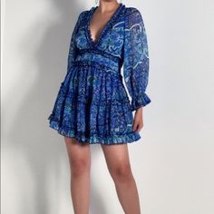 Paisley Type Print Frock Features A Floaty Chiffon Fabrication, Deep V Neckline, Bell Sleeves With Puffed Shoulders, Ruffle Trim, And A Plunging Open Back With Button Loop Closures At The Neck. Tags Still Attached Can’t Fit It 100% Polyester 32.5” Shoulder To Hem, 22” Sleeves Blue Floral Print Chiffon Mini Dress, Blue Floral Chiffon Mini Dress, Blue Chiffon Mini Dress For Vacation, Blue Long Sleeve Mini Dress With Ruffles, Blue Chiffon Mini Dress With Long Sleeves, Blue Chiffon Long Sleeve Mini Dress, Blue Long Sleeve Chiffon Mini Dress, Flowy Blue Mini Dress With Ruffle Hem, Blue Long Sleeve Mini Dress With Ruffle Hem