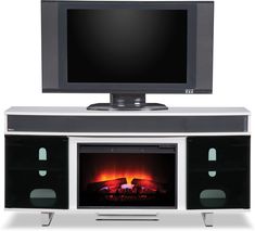 an entertainment center with a television and fire place