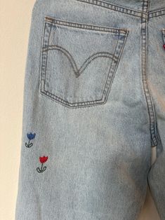 Hand Embroidered Levis - Etsy Embroidered Wide Leg Denim Jeans, Spring Embroidered Denim Blue Pants, Denim Blue Floral Embroidery Wide Leg Jeans, Wide Leg Denim Blue Jeans With Floral Embroidery, Trendy Straight Leg Pants With Floral Embroidery, Denim Straight Leg Pants With Floral Embroidery, Vintage Pants With Floral Embroidery For Spring, Straight Leg Denim Pants With Floral Embroidery, Embroidered Wide Leg Medium Wash Jeans