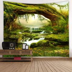 an image of a forest scene with stream and trees tapestry wall hanging on the wall