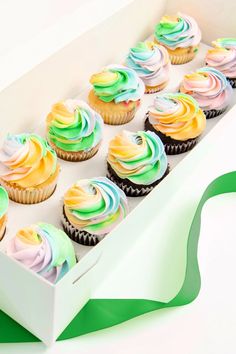 a box filled with cupcakes sitting on top of a table