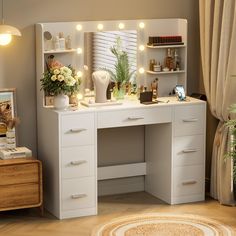 a white vanity with lights on it and flowers in vases next to the mirror