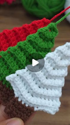 crocheted christmas tree ornament being held by someone