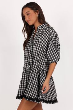 DETAILS  Designed for the fashion-forward woman who appreciates both comfort and style, this mini dress is a versatile addition to your wardrobe. Whether you're pairing it with sandals for a casual day out or dressing it up with heels for a chic evening look.    mini length  high round neckline  short sleeves  functional button down  ric rac trim on hem  gingham print  unlined  material - 100% cotton    SIZING     model is 5' 7" and wears a Size S    model stats: bust - 33", waist - 26", hips - Black Mini Plaid Dress For Picnic, Black Plaid Mini Dress For Picnic, Summer Black Plaid Dress, Casual Gingham Mini Dress, Black Plaid Mini Dress For Summer, Spring Black Plaid Mini Dress, Black Plaid Mini Dress For Spring, Chic Plaid Beach Dress, Summer Plaid Black Dress For Picnic