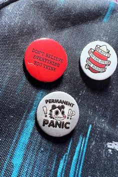 three buttons that say, don't believe everything is not think