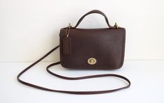 Coach Casino in brown leather. This black Coach Casino is in very good vintage condition. The bag has expected light wear. Made in the United States, No 9924. Bag has hangtag.  8 inches wide 5 inches tall 1.5 inches deep 52 inch strap I ship worldwide. Thanks for looking! Sling Bags, Cross Body Handbags, Purses And Handbags, Casino, Brown Leather, Satchel, United States, Purses And Bags, Handbags