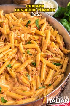 chicken sundried tomato pasta in a pan with basil leaves on the side and text overlay