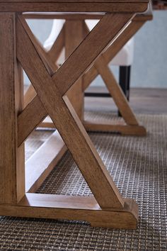 a wooden table sitting on top of a carpeted floor