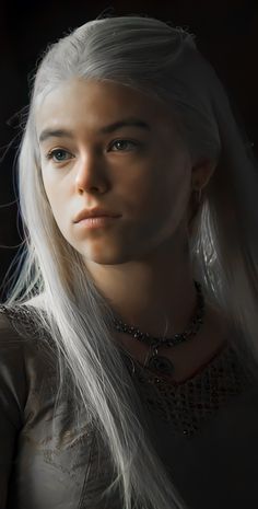 a woman with long white hair wearing a necklace