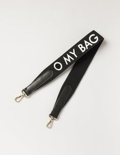 Made from a black cotton canvas, our canvas logo strap is here to make a statement with our O My Bag logo printed on one side. Featuring our signature brass clasps, you can attach this strap to almost any O My bag. Our personal favourite is the Gina Baguette x canvas logo strap combo. Slightly shorter than our regular webbing straps, this canvas logo strap measures 72cm in length for an effortless on-the-shoulder look. Combine this strap with any O My Bag with a detachable strap. OMB-blackwebbin Trendy Black Bag Strap For On-the-go, Black Crossbody Shoulder Bag With Letter Print, Black Letter Print Crossbody Shoulder Bag, Canvas Bags With Logo Strap For Travel, Trendy Black Shoulder Bag With Logo, Travel Canvas Bag With Logo Strap, Canvas Travel Bag With Logo Strap, Everyday Bags With Logo Strap, Adjustable Logo Strap Travel Bag