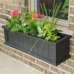 a window box filled with flowers on the side of a building