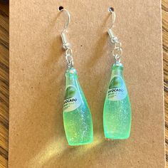 Soda Earrings With Silver Looking Wires And A Random Gift Bag. My Granddaughter Is Making These So She Can Get Some Money. Everything She Sells Will Go Right To Her. I Am Not Keeping Any Of The Money. She Is 11 Years Old. Slay Clothes, Rasta Earrings, Creepy Earrings, Glue Art, Tahitian Pearl Earrings, Teardrop Jewelry, Handmade Skulls, Blue Crystal Earrings, Funky Earrings