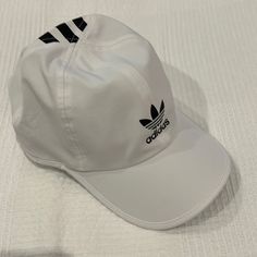 Adidas Superlite Training Hat Nwot Brand New Never Worn. Size: One Size Color: White With Black Adidas Logo And Classic 3 Stripes. Material: 67% Recycled Polyester, 13% Spandex Adidas Sporty Hats For Summer, Adjustable White Adidas Hat, Adidas White Curved Brim Hat, Sporty White Bucket Hat, White Adidas Sporty Baseball Cap, Adidas White Baseball Cap For Streetwear, White Baseball Cap For Outdoor, Adidas Bucket Hat, Adidas Baseball Cap