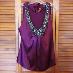 Color Is Currant Deep V Neckline Is Heavily Embellished Size Small Purple Embellished Sleeveless Top, Chic Sleeveless Embellished Tops, Sleeveless Embellished Tops For Night Out, Embellished Blouse For Night Out, Formal Sleeveless Embellished Top, Elegant Purple Festive Top, Elegant Purple Top For Festive Occasions, Elegant Festive Purple Top, Womens Silk Shirts