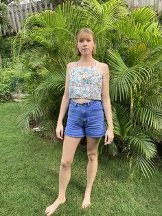 This reversible crop top is made from 100% recycled fabric, one side from a fish-patterned aloha shirt and the other from a block-patterned aloha shirt. It fits a 32"34" bust. Floral Print Cropped Top For Beach, Beach Tops With Floral Print And Short Length, Floral Print Cropped Crop Top For Beach Season, Beach Floral Print Short Tops, Beach Season Floral Crop Top, Floral Print Short Length Tops For Beach, Short Floral Print Tops For Beach, Printed Cropped Crop Top For Day Out, Printed Cropped Top For Day Out