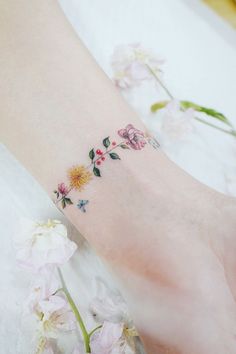 a woman's foot with flowers on it