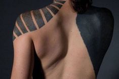 the back of a man's body with black and white lines painted on it